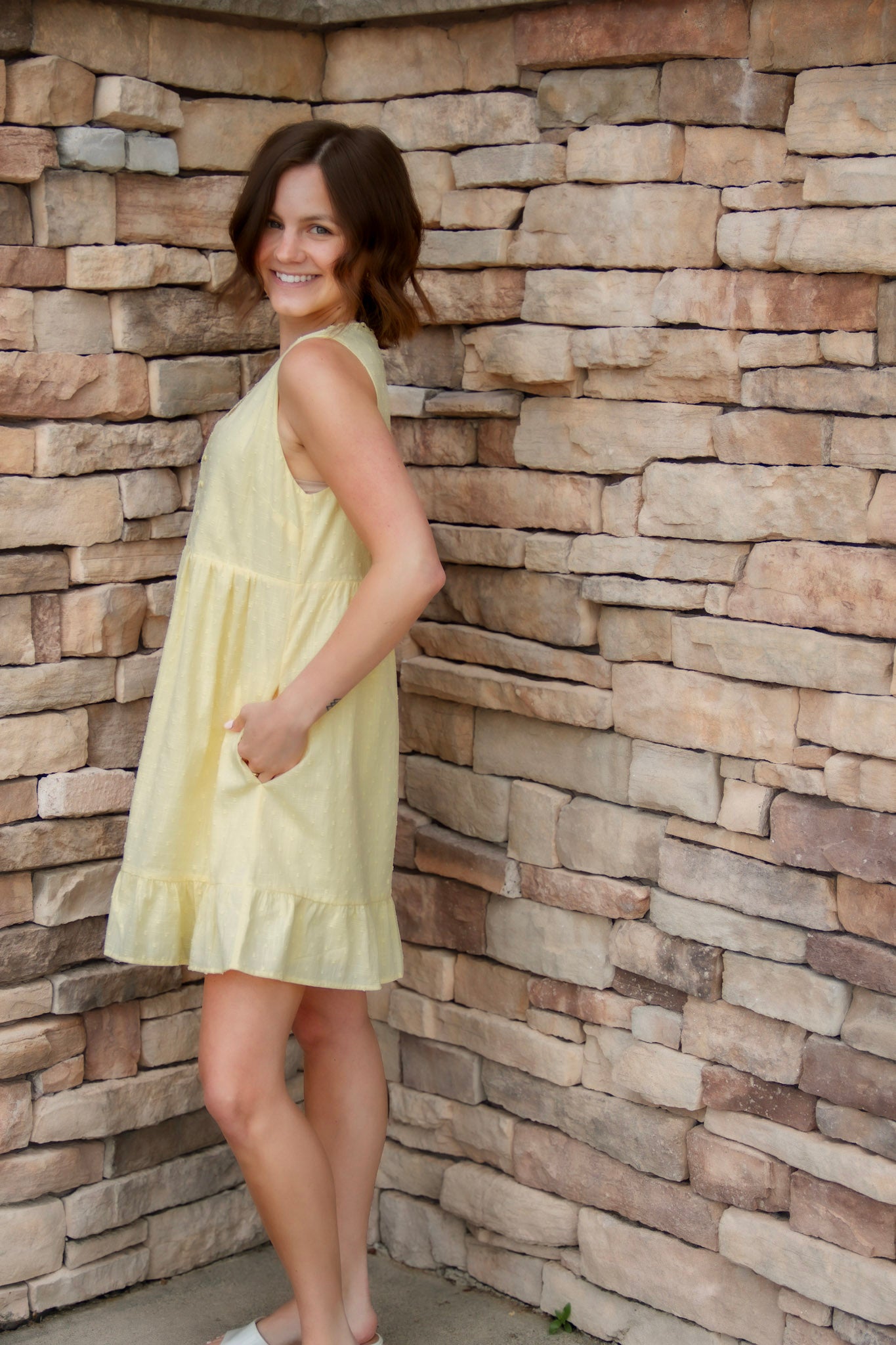 yellow mini dress with textured detail, v-neck and buttons down the front
