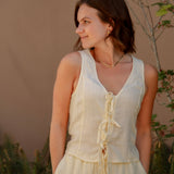 yellow sleeveless tank top with ties on the front and a matching yellow linen pant